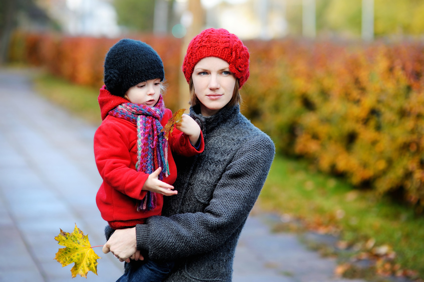 Young mother and her toddler girl in autumn
